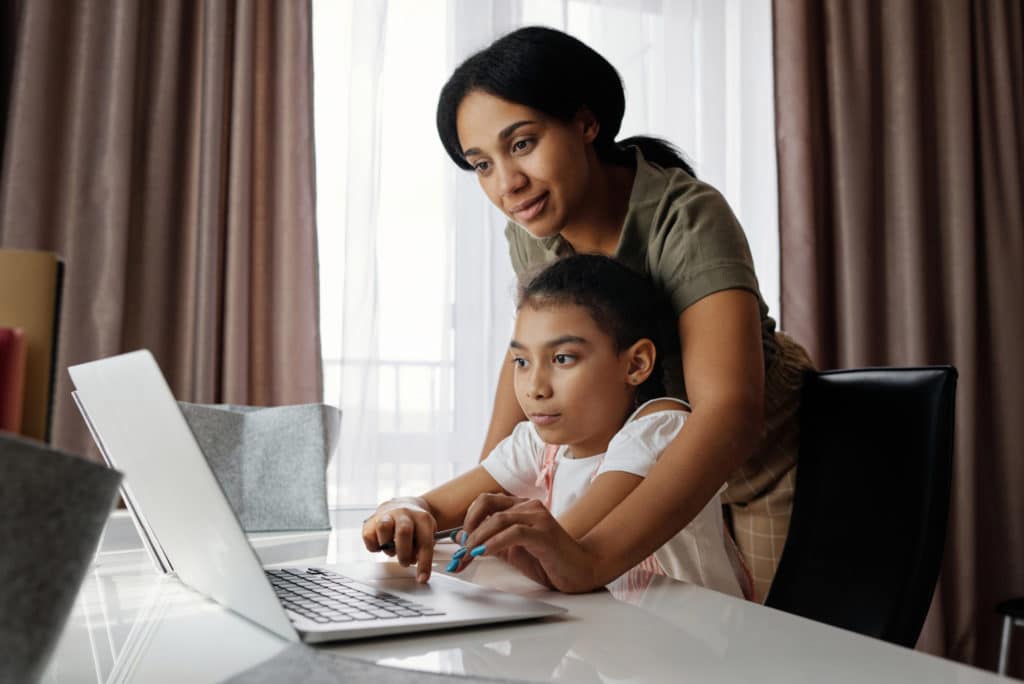 picture of mother helping student on computer